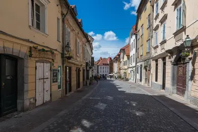 an empty street in an old town with buildings at Barrio Alto in Ljubljana