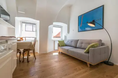 a living room with a couch and a table at Barrio Alto in Ljubljana