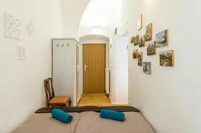 a bedroom with a bed with blue pillows at Barrio Alto in Ljubljana