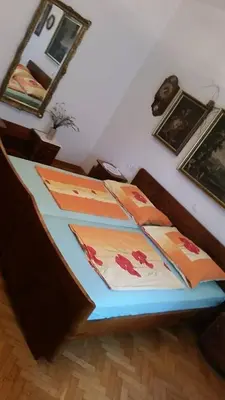a bedroom with a bed with paintings on it at Apartment Tatjana in Ljubljana
