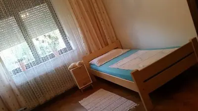 a small bedroom with a bed next to a window at Apartment Tatjana in Ljubljana