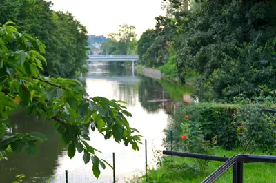 a river with a bridge in the middle of it at Apartment Soul in Ljubljana