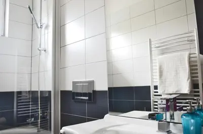 a bathroom with a sink and a shower with a mirror at Apartment Soul in Ljubljana