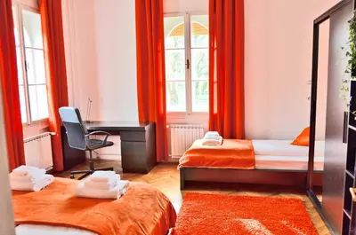 a room with two beds and a desk in it at Apartment Soul in Ljubljana
