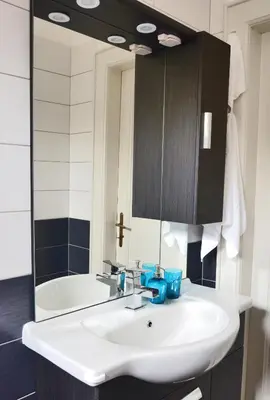 a bathroom with a sink and a mirror and a tub at Apartment Soul in Ljubljana