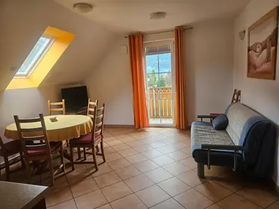 a living room with a table and a couch at Apartmaji Mlinar in Kranjska Gora