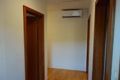 an empty room with a door and a air conditioner at Apartment Beks in Postojna