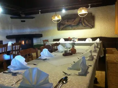a dining room with a long table with white table cloth at Gostišče Smuk in Križe
