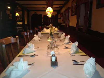 a long table in a restaurant with a white table cloth at Gostišče Smuk in Križe