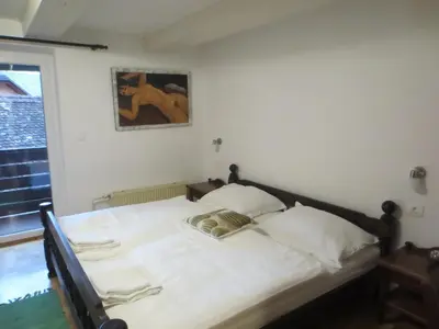 a bedroom with a bed with white sheets at Gostišče Smuk in Križe