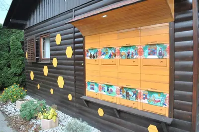 a house with a wall with yellow paint on it at Čebelarjeva hiška 1 - Terme Olimia - Podčetrtek in Podčetrtek