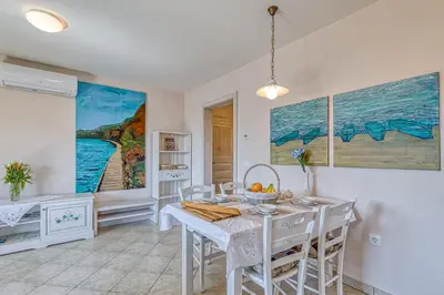 a dining room with a white table and chairs at Apartments ApArt Bled in Bled