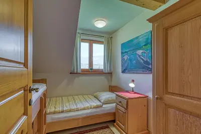 a small bedroom with a bed and a window at Apartments ApArt Bled in Bled