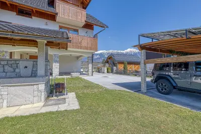 a jeep parked in a parking lot next to a building at Apartments ApArt Bled in Bled