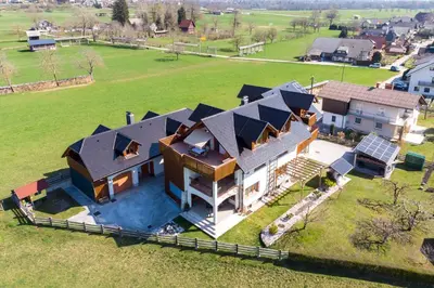 an aerial view of a large house with solar panels at Apartments ApArt Bled in Bled