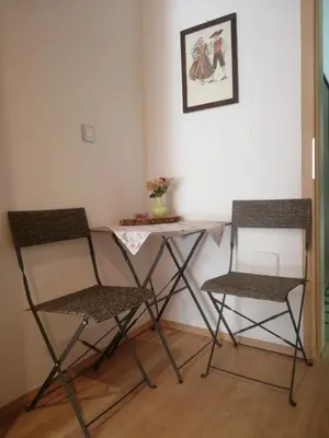 two chairs and a table in a room at Prenočišča Mraz in Velenje