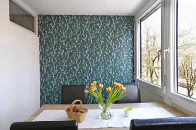 a dining room with a table with a vase of flowers at CastleView in Ljubljana