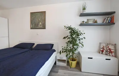a bedroom with a bed and a potted plant at CastleView in Ljubljana