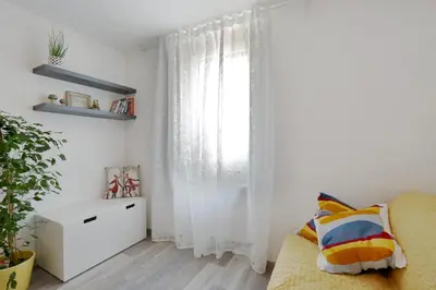 a white room with a window and a couch at CastleView in Ljubljana