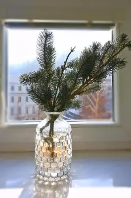 a vase with a christmas tree in a window at CastleView in Ljubljana