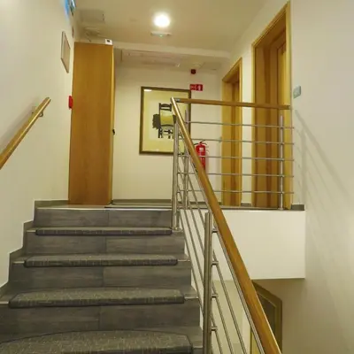 a stairway in a hospital with a fire extinguisher at Pan Prenočišča in Ptuj