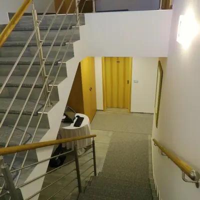 a hallway with a staircase in a building at Pan Prenočišča in Ptuj
