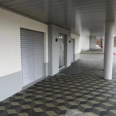 a hallway of a building with a tile floor at Pan Prenočišča in Ptuj