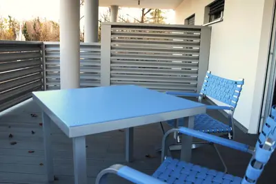 a white table and chairs on a balcony at Pan Prenočišča in Ptuj