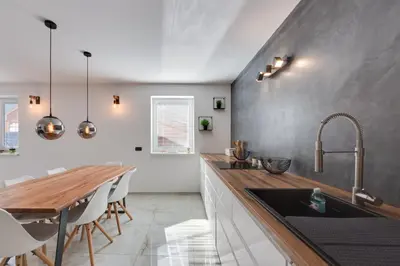 a kitchen with a sink and a wooden counter top at Apartments Julian Explore in Rateče