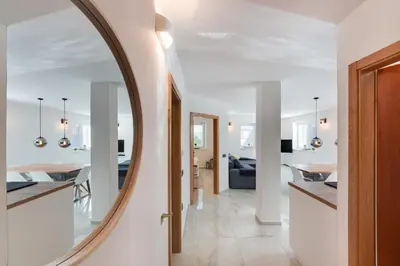 a large round mirror in a living room with a dining room at Apartments Julian Explore in Rateče
