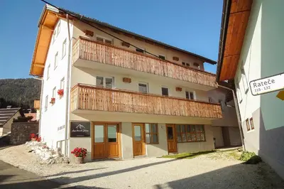 a large building with a balcony on top of it at Apartments Julian Explore in Rateče