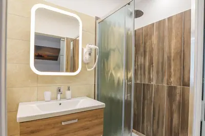 a bathroom with a sink and a mirror at Jazz Bled Guest House in Bled