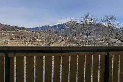 a wooden fence with a view of a mountain at Jazz Bled Guest House in Bled