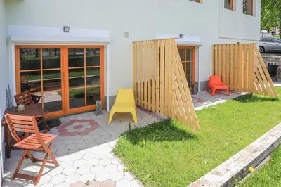 a backyard with two chairs and a swing at Jazz Bled Guest House in Bled