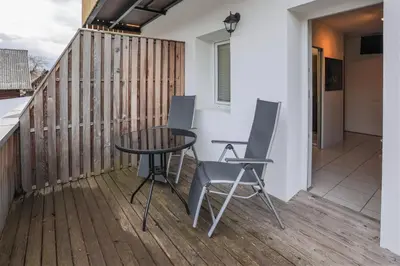 a patio with a table and chairs on a deck at Jazz Bled Guest House in Bled