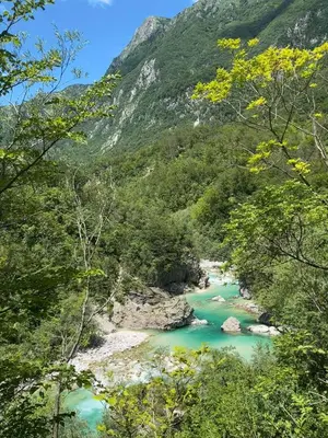 a river in the mountains with green water at Hisa Rejmr with private parking in Kobarid