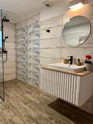a bathroom with a sink and a mirror at Hisa Rejmr with private parking in Kobarid