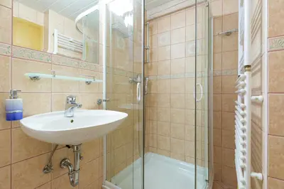a bathroom with a sink and a shower at Outstanding Lake View. in Kranjska Gora
