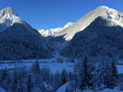 a view of a mountain range with snow covered mountains at Outstanding Lake View. in Kranjska Gora