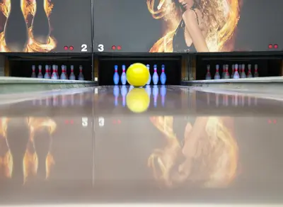 a yellow cue ball in a bowling alley at Hotel Dolenjc in Novo Mesto