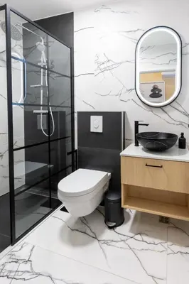 a bathroom with a toilet and a shower and a sink at Hotel Dolenjc in Novo Mesto