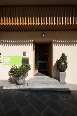 a entrance to a building with two potted plants at CUBE central rooms for 2 in Ljubljana