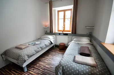a room with two beds and a window at CUBE central rooms for 2 in Ljubljana
