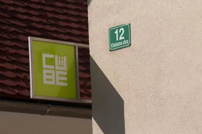 a green sign on the side of a building at CUBE central rooms for 2 in Ljubljana