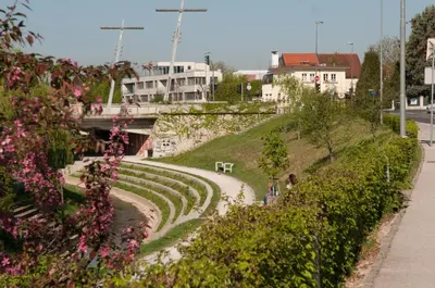 a winding road with flowers on the side of a hill at CUBE central rooms for 2 in Ljubljana