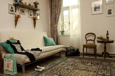 a living room with a couch and a chair at Trubarjev Art Boutique hotel in Laško