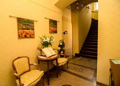 a hallway with a table and chairs and a staircase at Trubarjev Art Boutique hotel in Laško