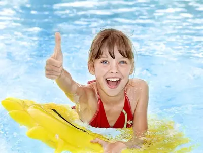a young girl in a pool giving a thumbs up at Trubarjev Art Boutique hotel in Laško