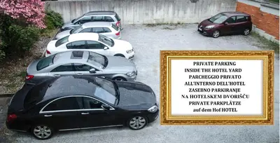 a row of parked cars in a parking lot at Trubarjev Art Boutique hotel in Laško