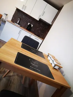 a wooden table in a kitchen with a counter at Apartments Ema in Podčetrtek